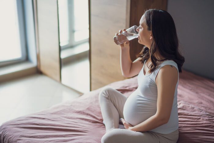 pregnant woman drinking water